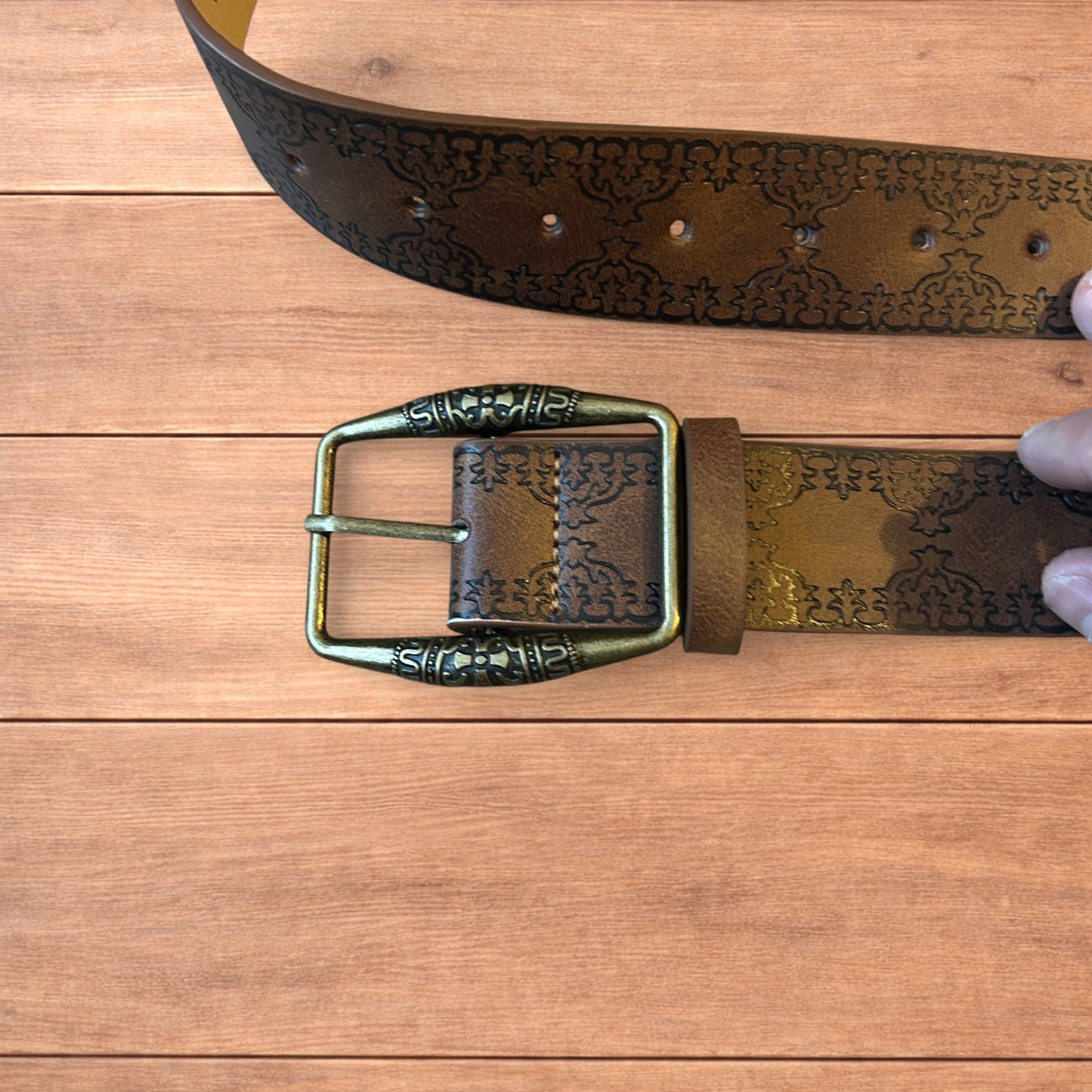 Vintage style faux leather western cowboy belt in brown with bronze trim.