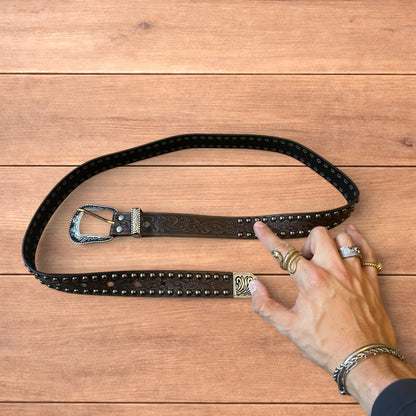 Vintage style faux leather western cowboy gothic belt in brown with silver trim.
