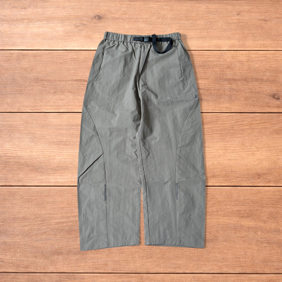 Baggy khaki green gorpcore tech hiking pants laid flat showing front and back details