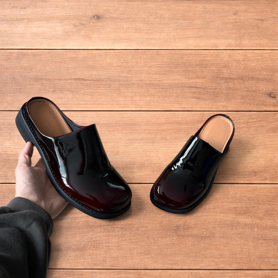 Faux leather slip on clogs slippers in oxblood red.