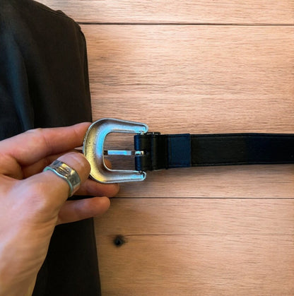 Vintage style faux leather western cowboy belt in black with silver trim. 105cm.