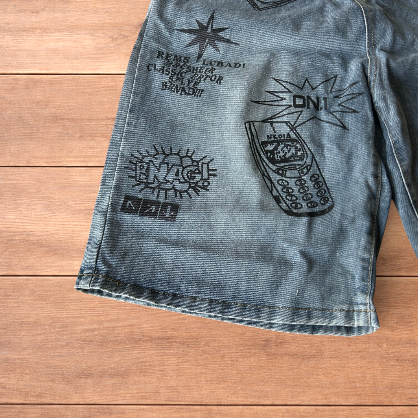 Incredible baggy wide leg denim shorts jorts with graffiti/graphic in light blue.