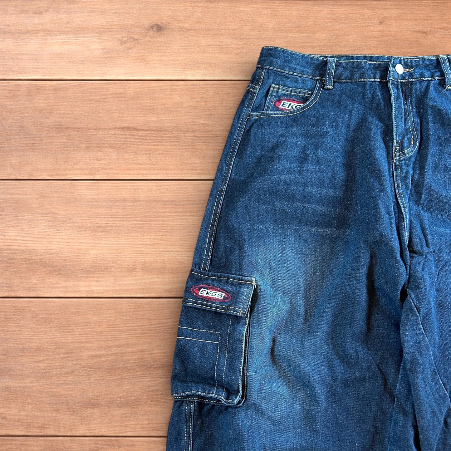 Vintage style baggy wide leg skater fit cargo jeans with embroidery in mid blue.
