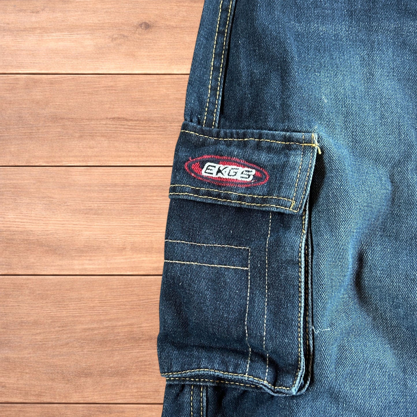 Vintage style baggy wide leg skater fit cargo jeans with embroidery in mid blue.