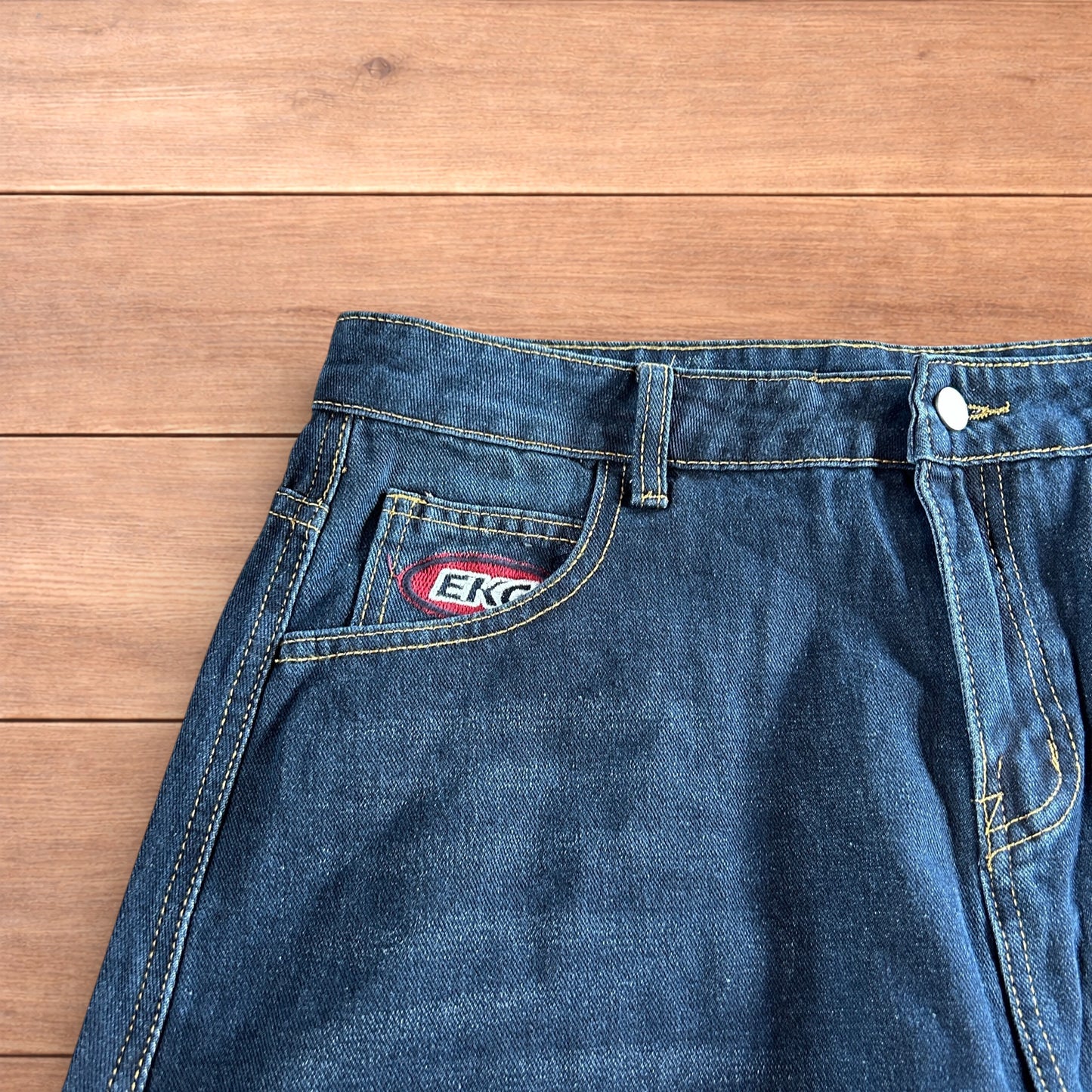 Vintage style baggy wide leg skater fit cargo jeans with embroidery in mid blue.