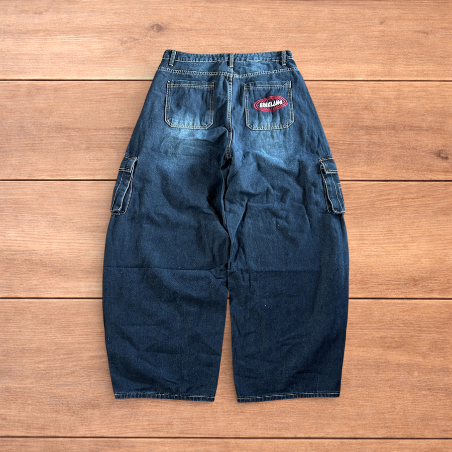 Mid blue vintage style baggy wide leg skater fit cargo jeans showing embroidered back pocket and cargo side pockets