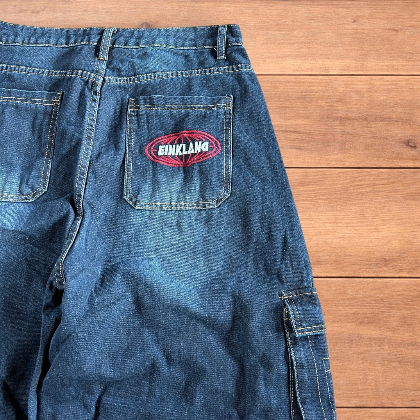 Vintage style baggy wide leg skater fit cargo jeans with embroidery in mid blue.