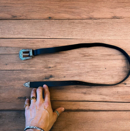 Vintage style faux leather western cowboy belt in black with silver trim. 100cm.