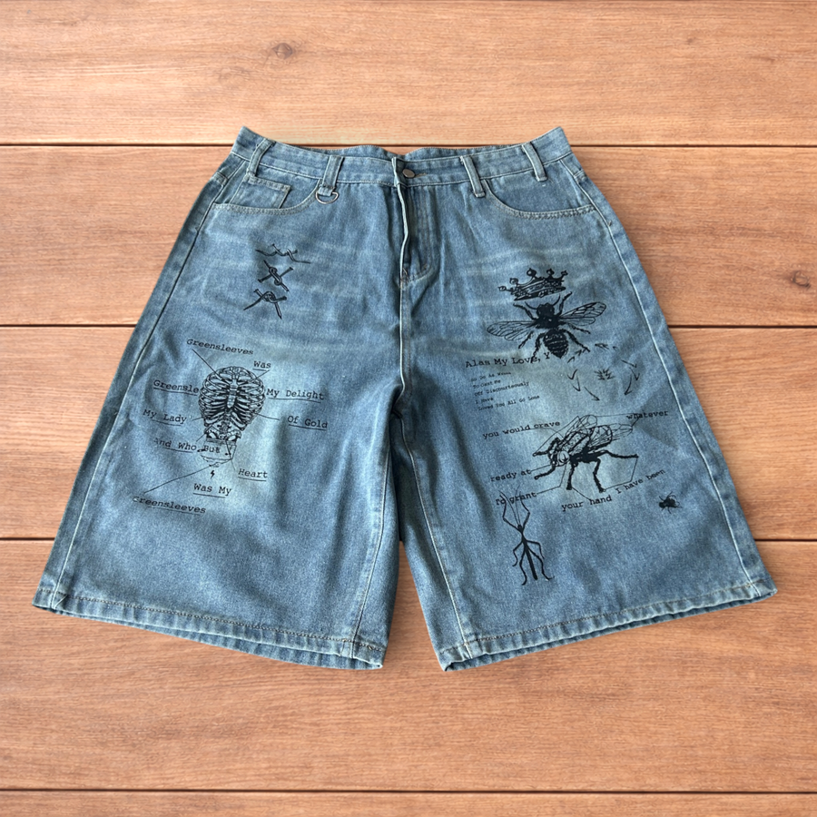 Light blue baggy wide leg denim shorts with black graffiti and graphic prints on front and back pockets