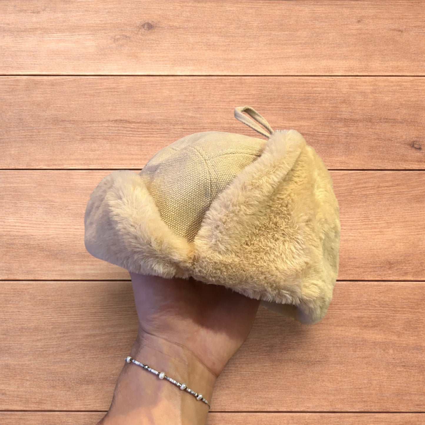 Russian ushanka trapper ear flap winter hat in cream/beige colour way.