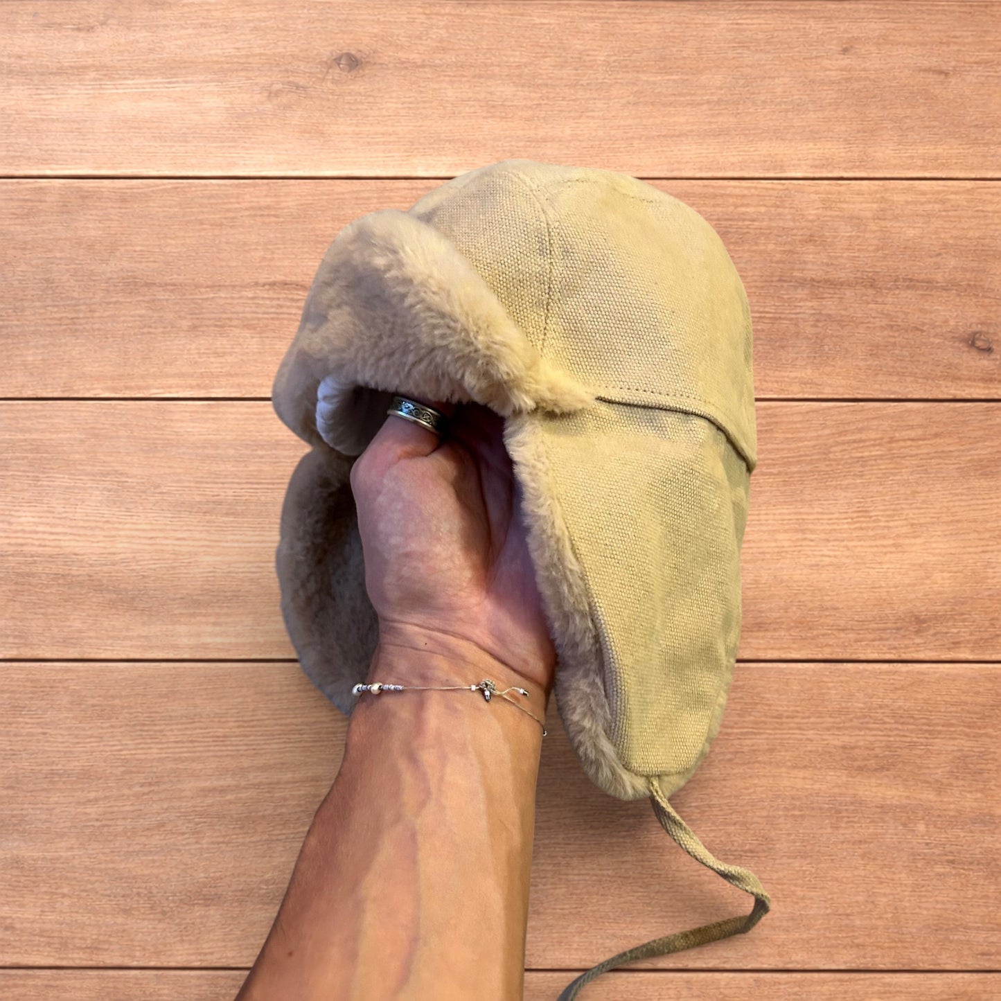 Russian ushanka trapper ear flap winter hat in cream/beige colour way.