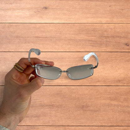 Lovely rimless rectangle frame sunglasses in clear and silver.
