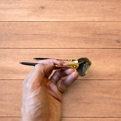 Insane metal frame sunglasses in gold with multicolour rainbow lense.