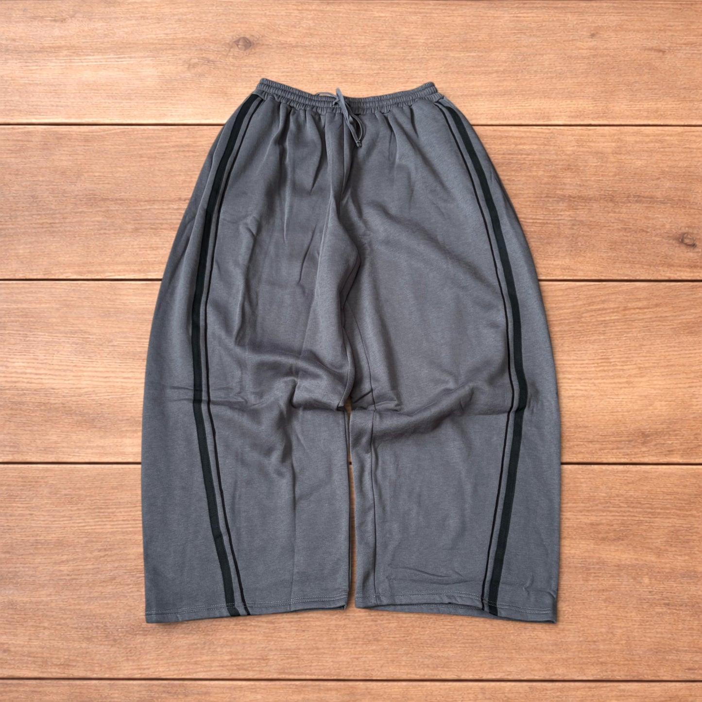 Super baggy wide leg Korean joggers with side stripes in dark grey.