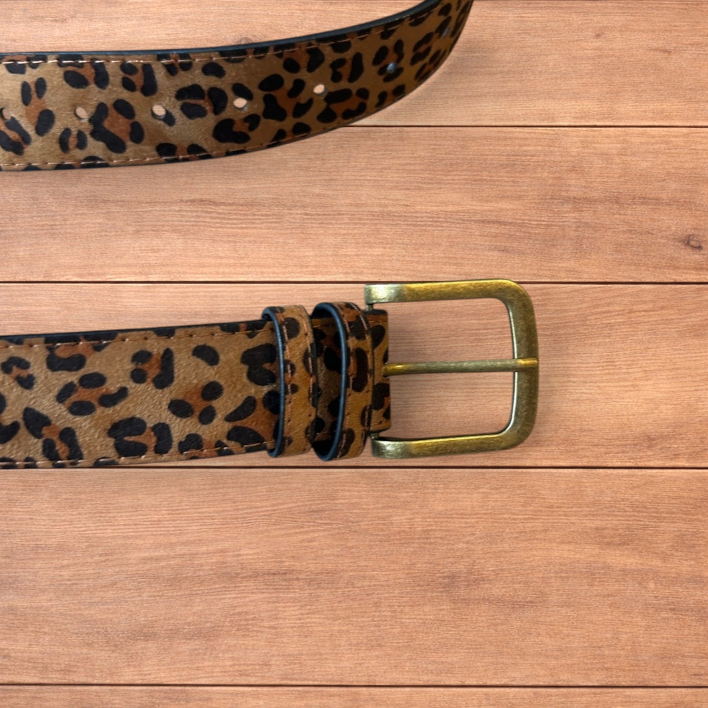Vintage style faux leather western leopard cowboy belt with bronze trim.