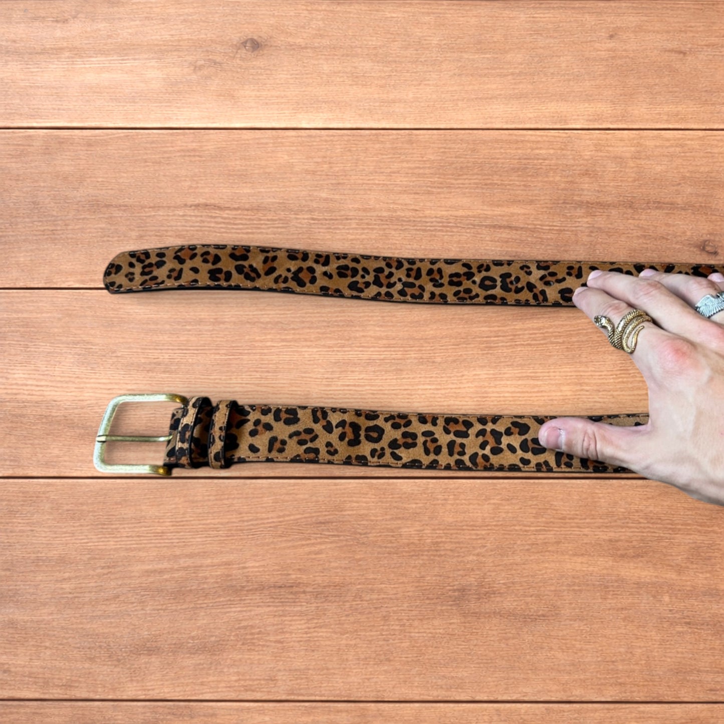 Vintage style faux leather western leopard cowboy belt with bronze trim.