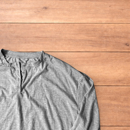Relaxed fit henley long sleeve top in marl grey laid flat on wooden surface