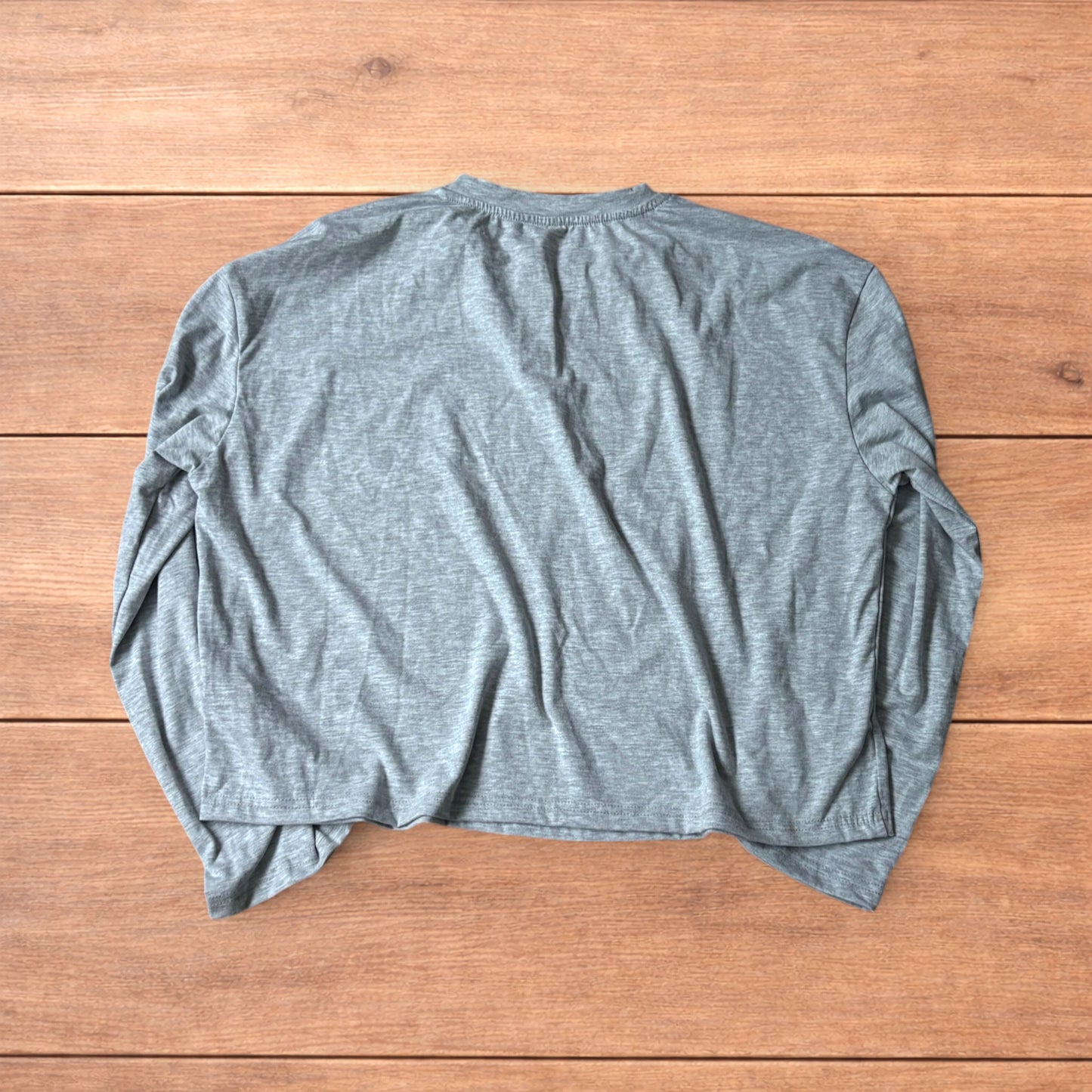 Relaxed fit henley long sleeve top in marl grey laid flat on wooden surface