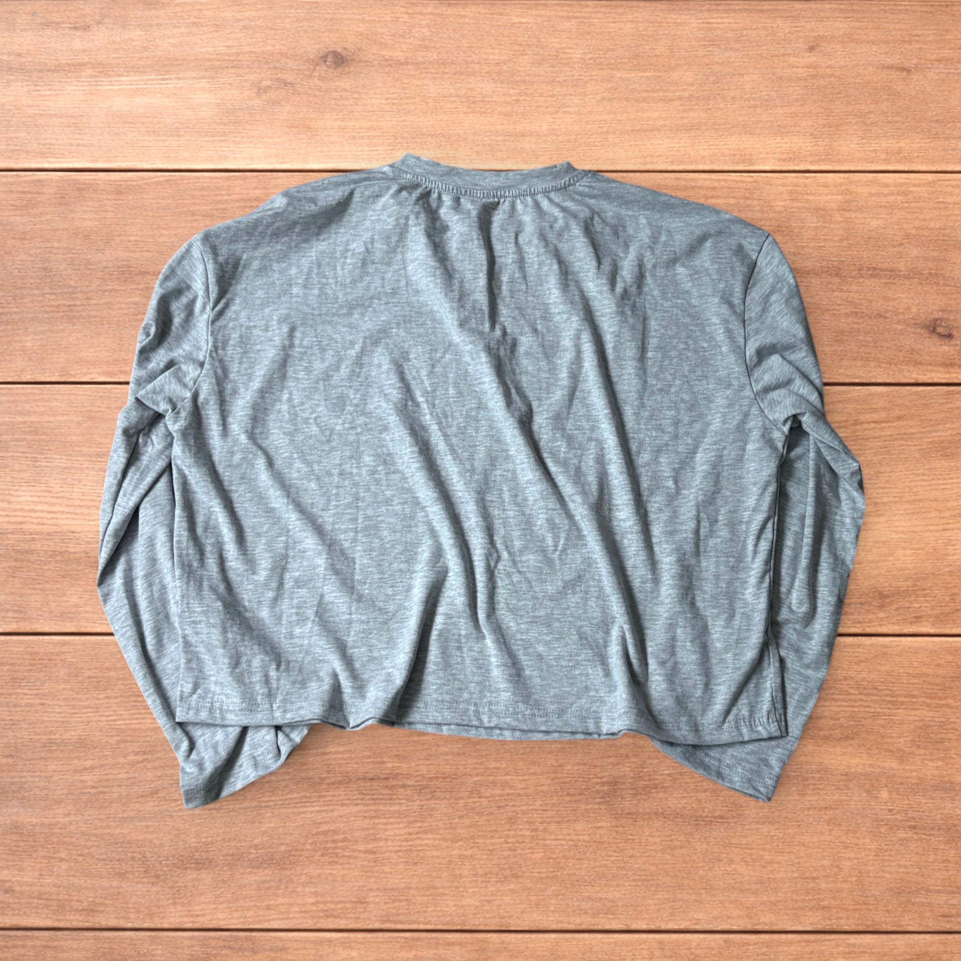 Relaxed fit henley long sleeve top in marl grey laid flat on wooden surface