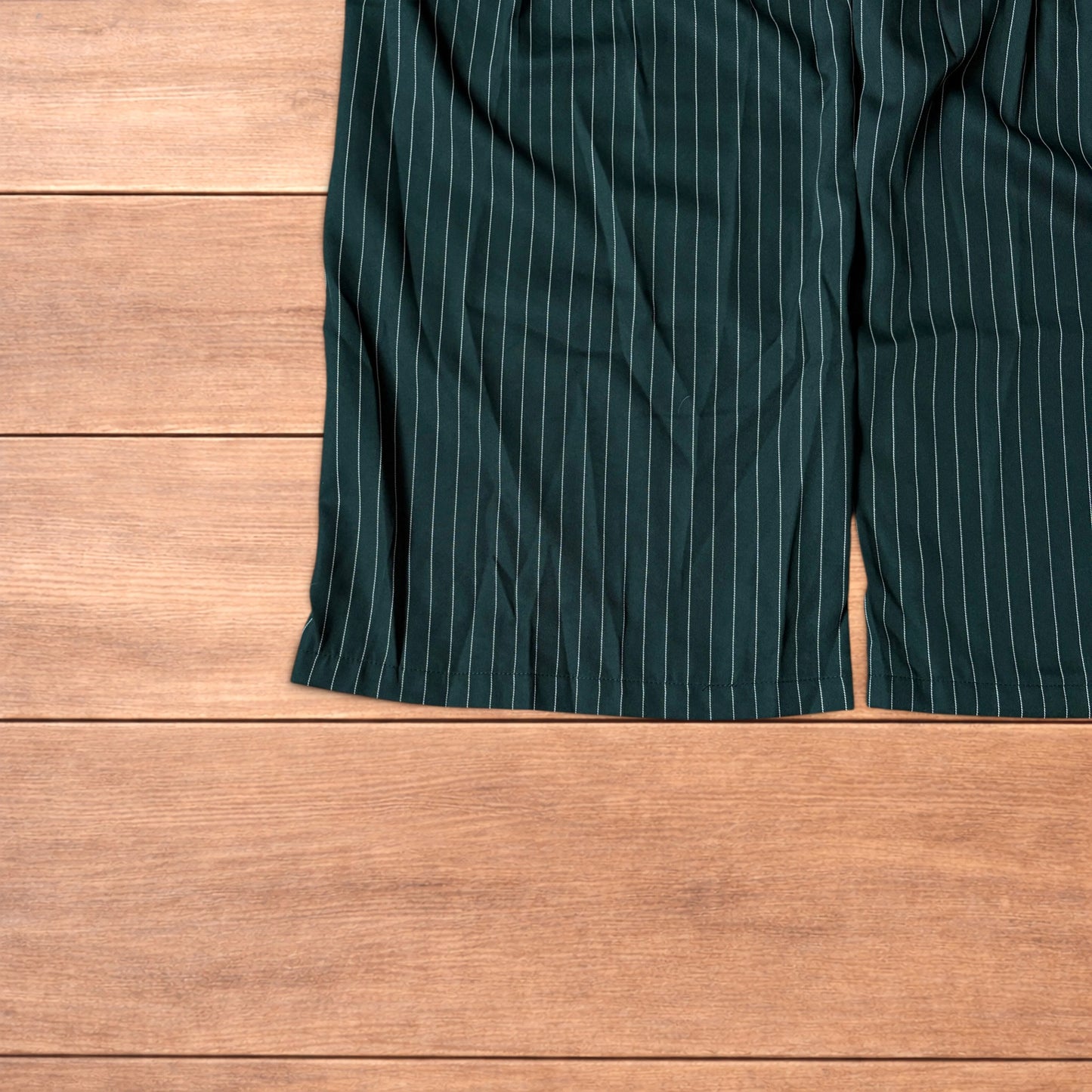Vintage style baggy wide leg dark green trousers with white pinstripe, button and zip fastening, laid flat