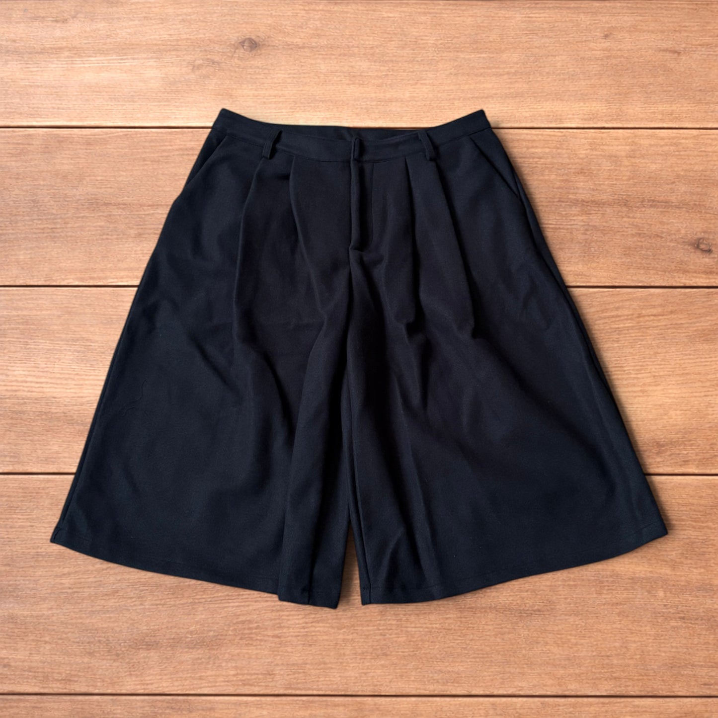 Vintage style baggy wide leg long tailored wool shorts in black.