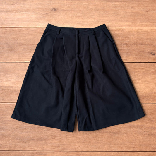 Vintage style baggy wide leg long tailored wool shorts in black.
