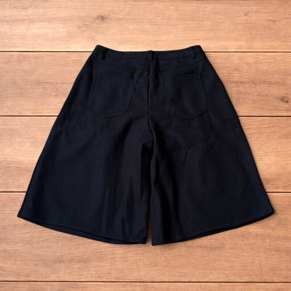 Vintage style baggy wide leg long tailored wool shorts in black.