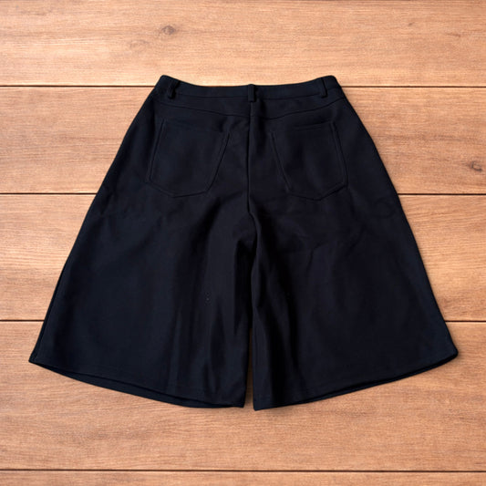 Vintage style baggy wide leg long tailored wool shorts in black.