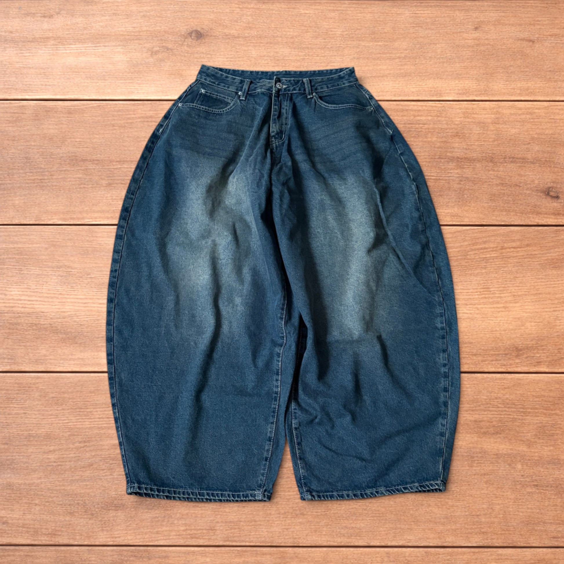 Super baggy wide leg balloon fit dark blue jeans laid flat showing front, back and pockets