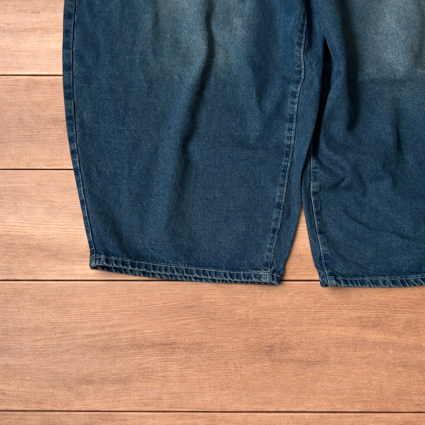 Super baggy wide leg balloon fit dark blue jeans laid flat showing front, back and pockets