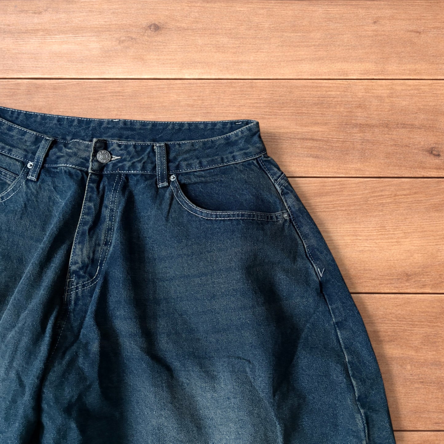 Super baggy wide leg balloon fit dark blue jeans laid flat showing front, back and pockets