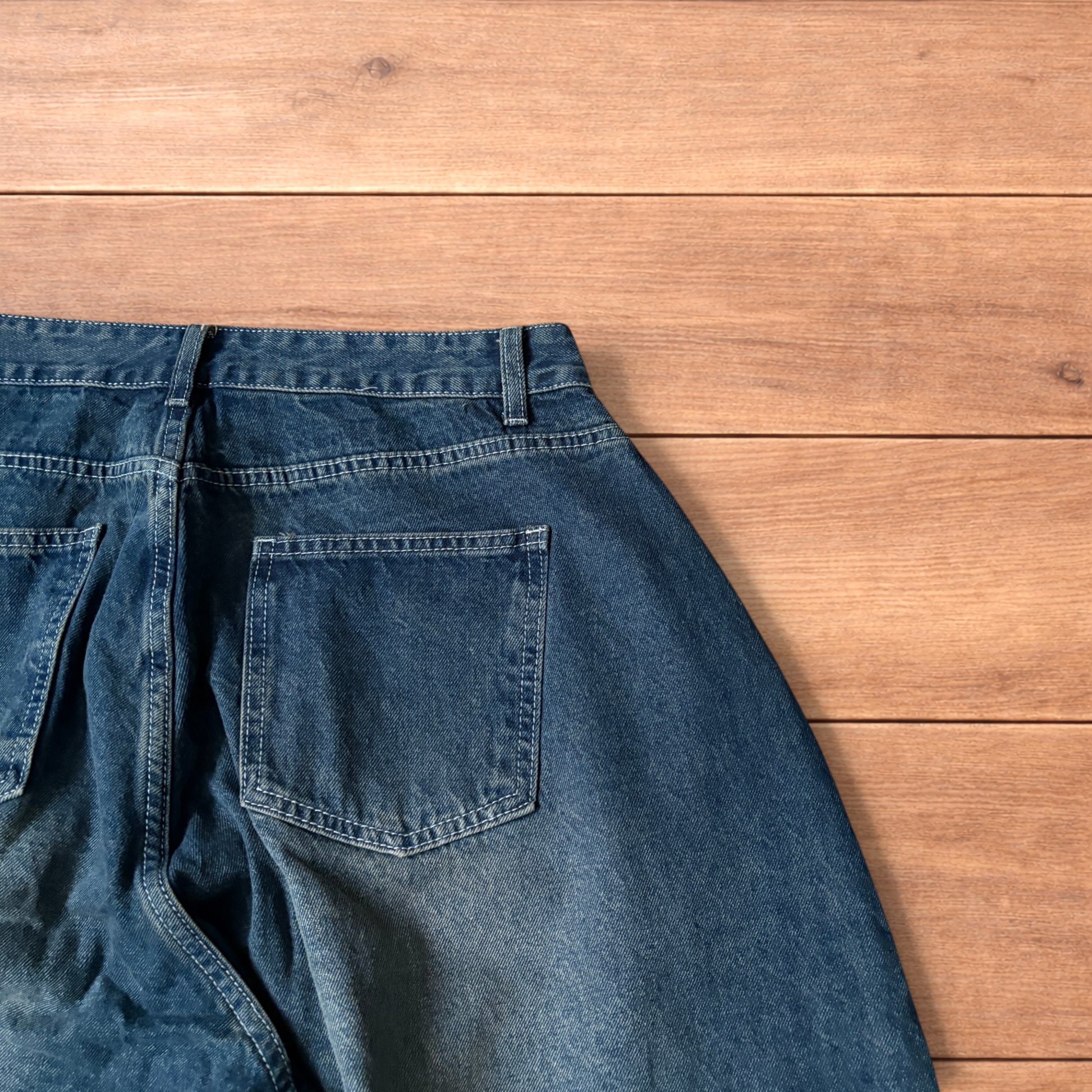 Super baggy wide leg balloon fit dark blue jeans laid flat showing front, back and pockets