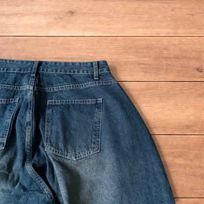 Super baggy wide leg balloon fit dark blue jeans laid flat showing front, back and pockets