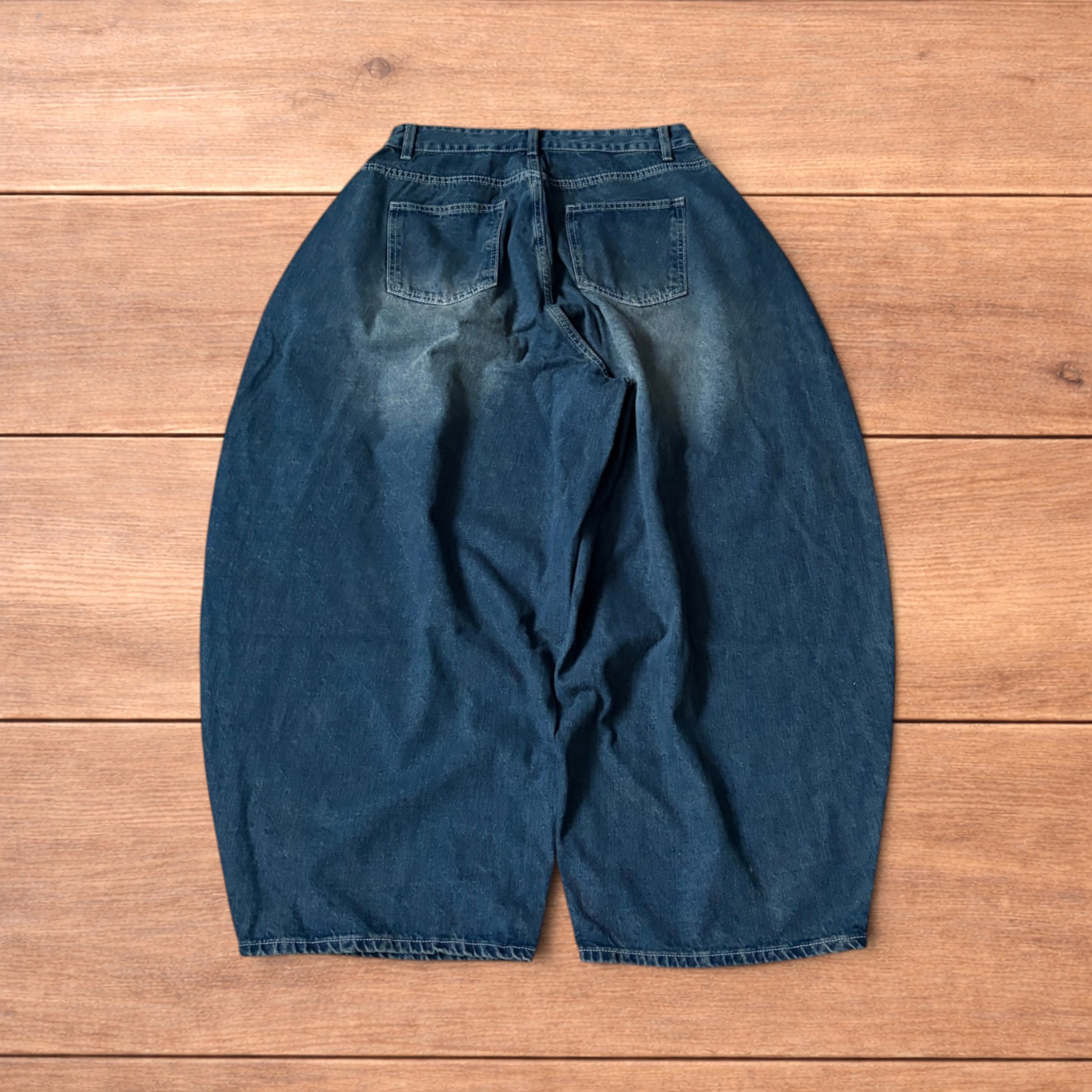 Super baggy wide leg balloon fit dark blue jeans laid flat showing front, back and pockets