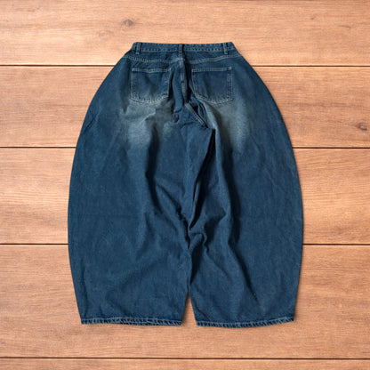 Super baggy wide leg balloon fit dark blue jeans laid flat showing front, back and pockets