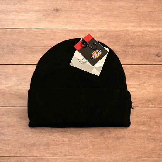 Black Dickies 3M Thinsulate beanie with patch logo on folded cuff, laid flat on wooden surface.
