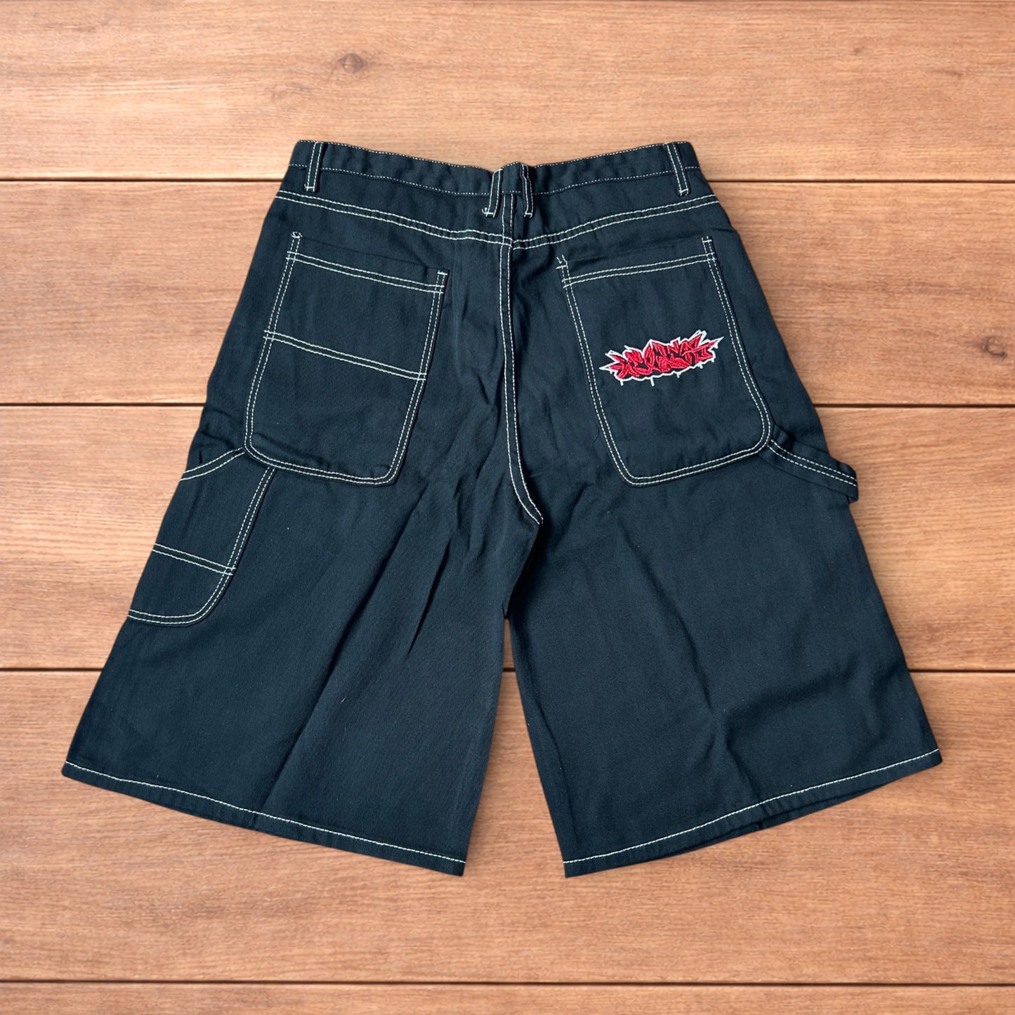 Insane super baggy long skater jean shorts jorts in black with embroidered design.