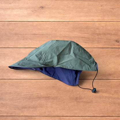 Lightweight reversible military pilot trapper hat in green/purple.