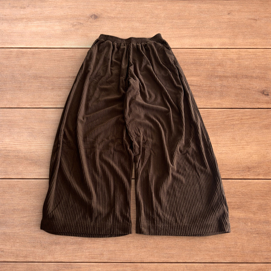 Brown super baggy wide leg relaxed fit corduroy trousers joggers laid flat showing waistband and leg details.