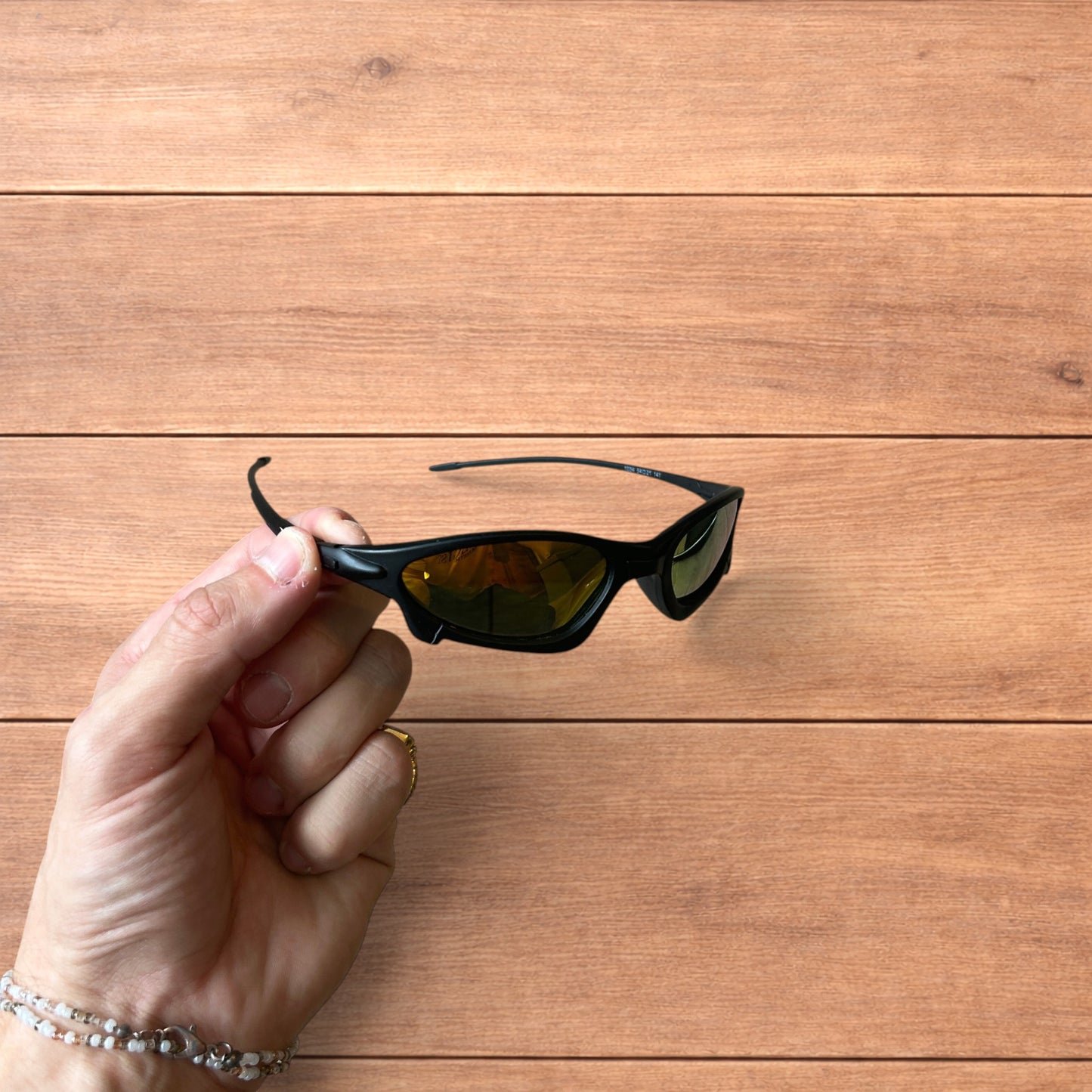 Insane polarised sunglasses in black with orange reflective lense.