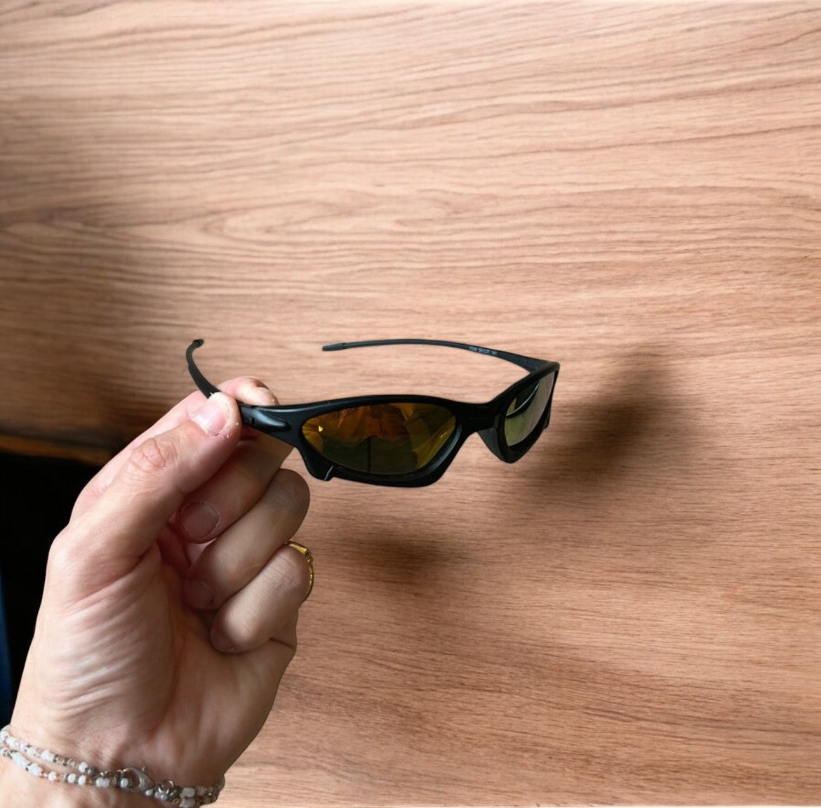 Insane polarised sunglasses in black with orange reflective lense. One size.