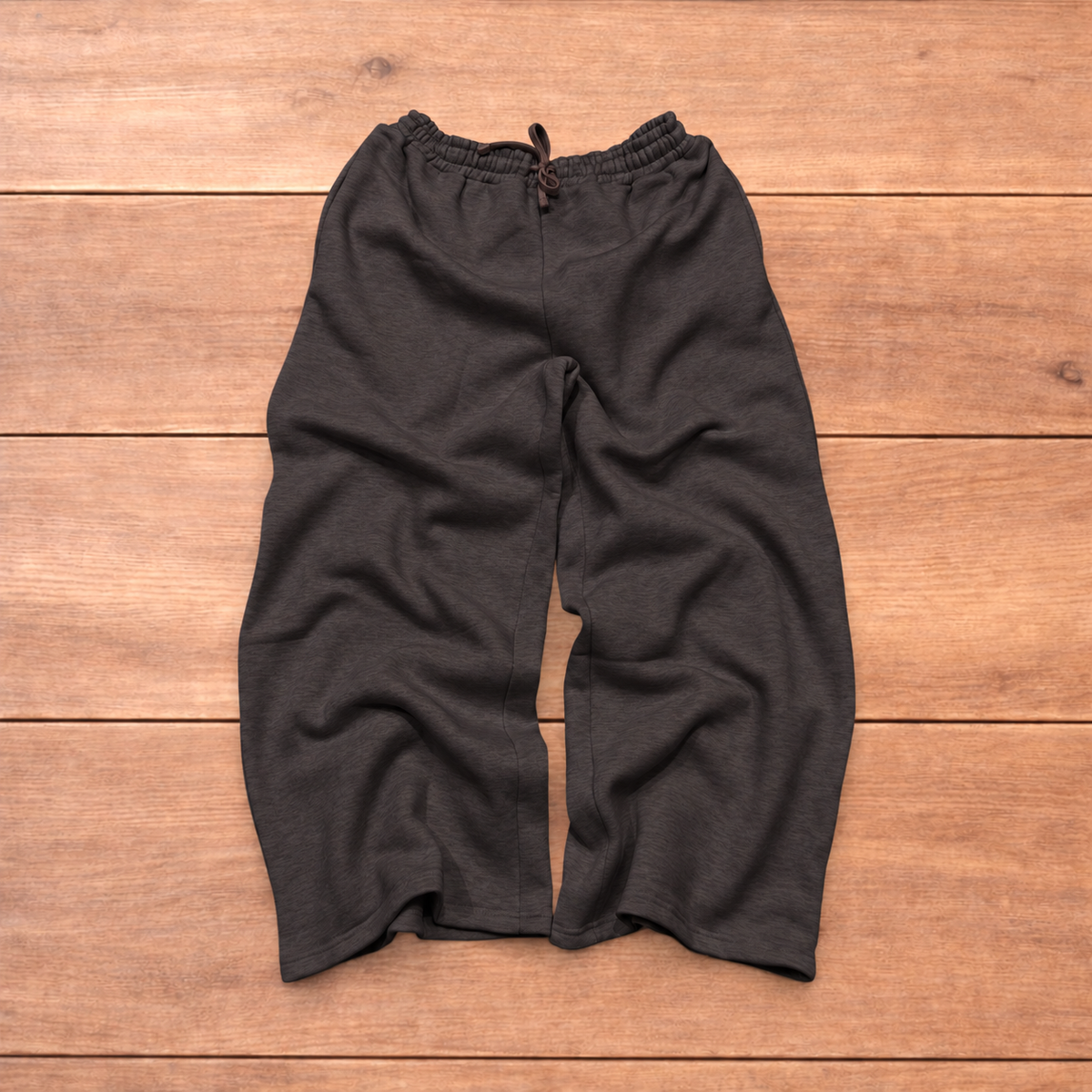 Navy baggy joggers featuring a white and burgundy check pattern laid flat on wood surface.