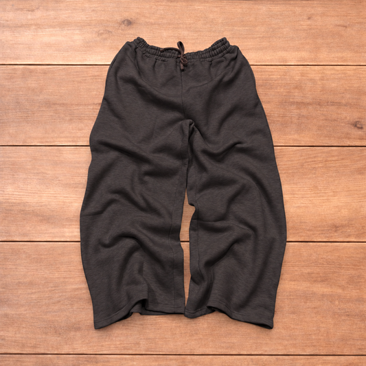Navy baggy joggers featuring a white and burgundy check pattern laid flat on wood surface.
