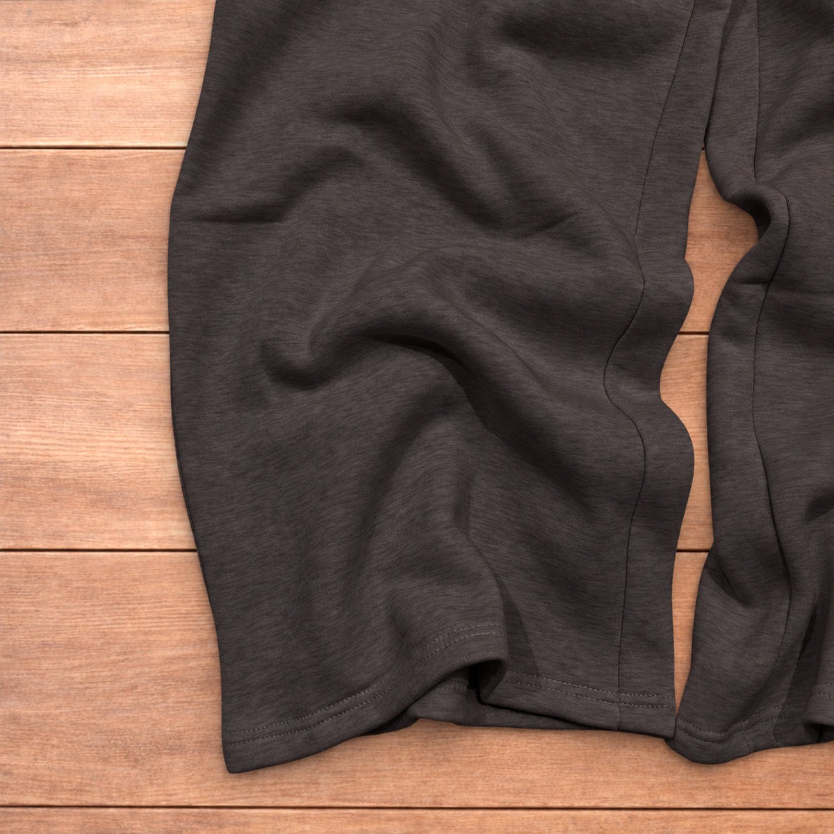 Navy baggy joggers featuring a white and burgundy check pattern laid flat on wood surface.