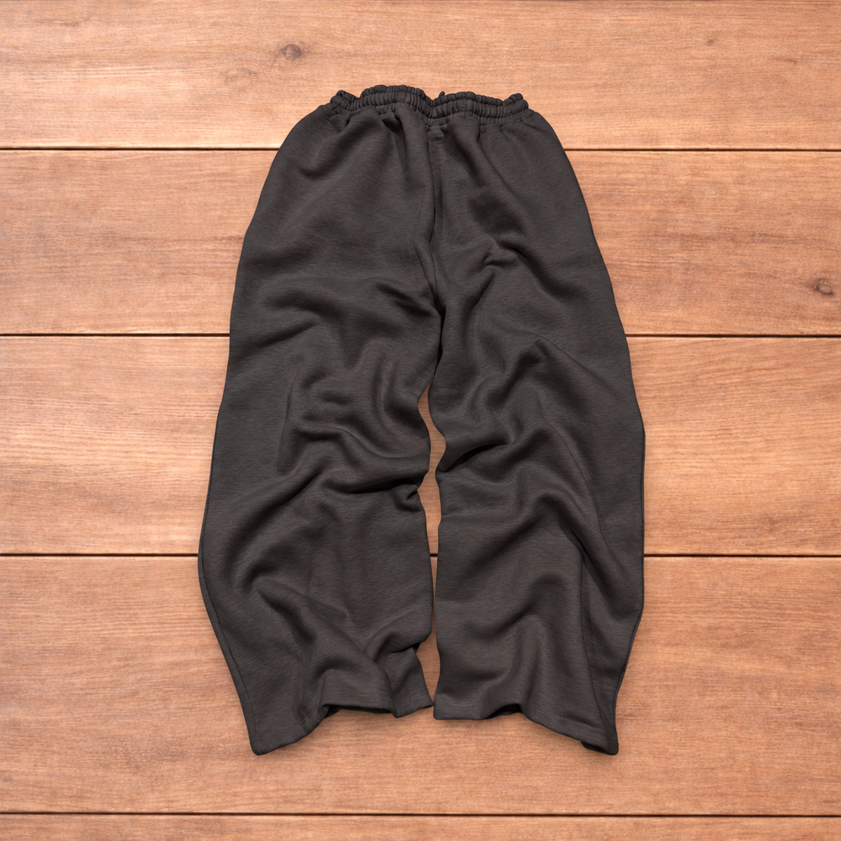 Navy baggy joggers featuring a white and burgundy check pattern laid flat on wood surface.
