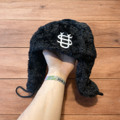Russian ushanka trapper ear flap winter hat in black colour way.