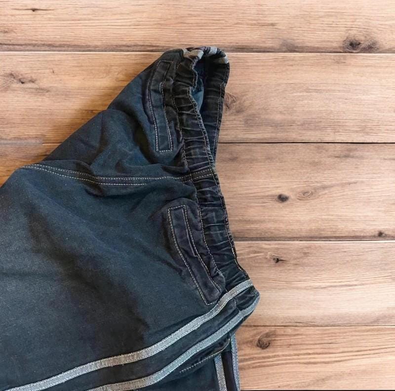 Vintage style baggy wide leg skater fit jeans with side stripes in washed black.