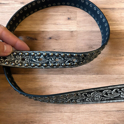 Vintage style faux leather western cowboy gothic belt in black with silver trim.