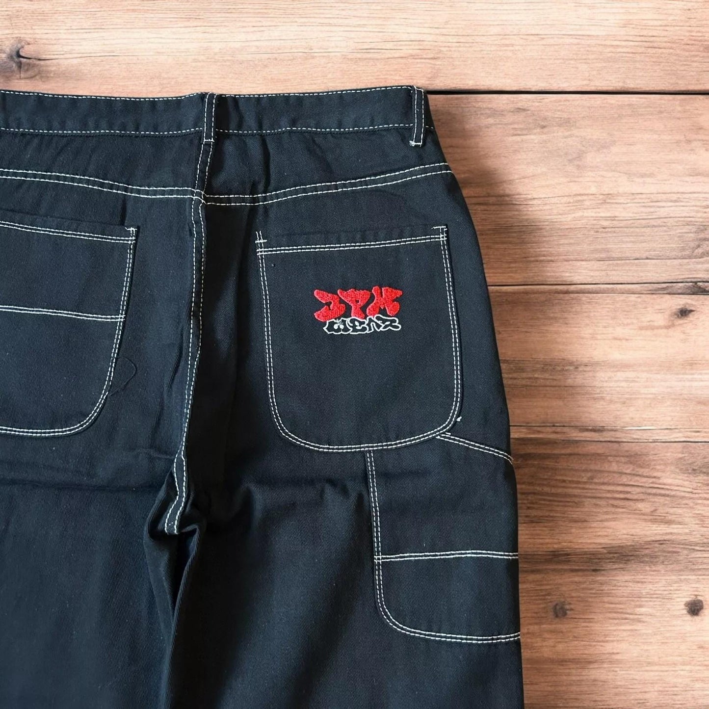 Insane baggy relaxed fit jeans washed black with red embroidery.