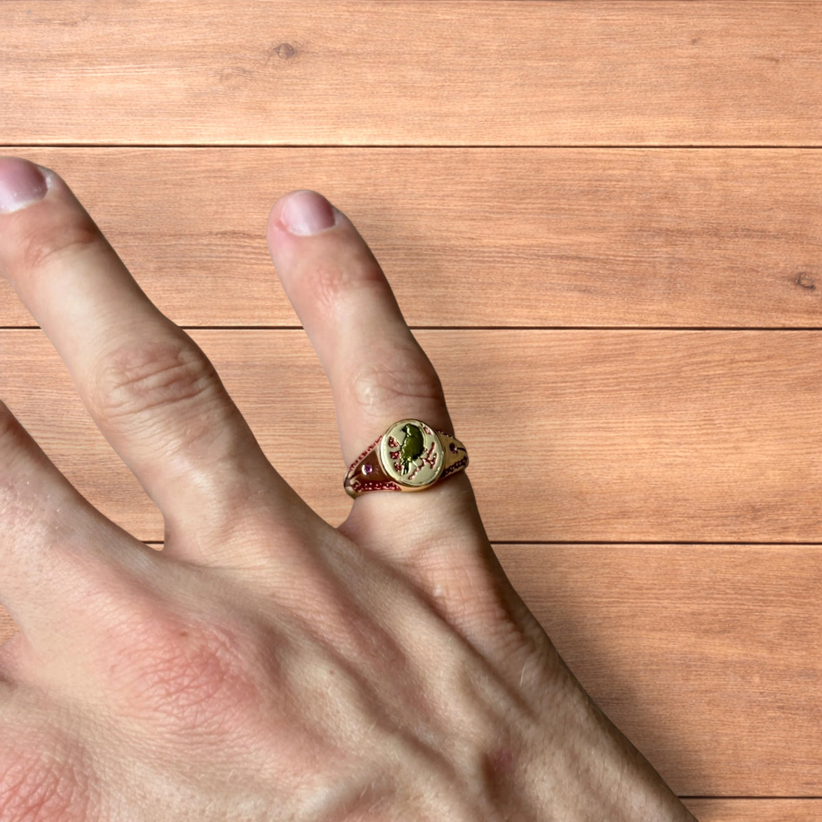 Vintage style signet ring with bird design in gold.